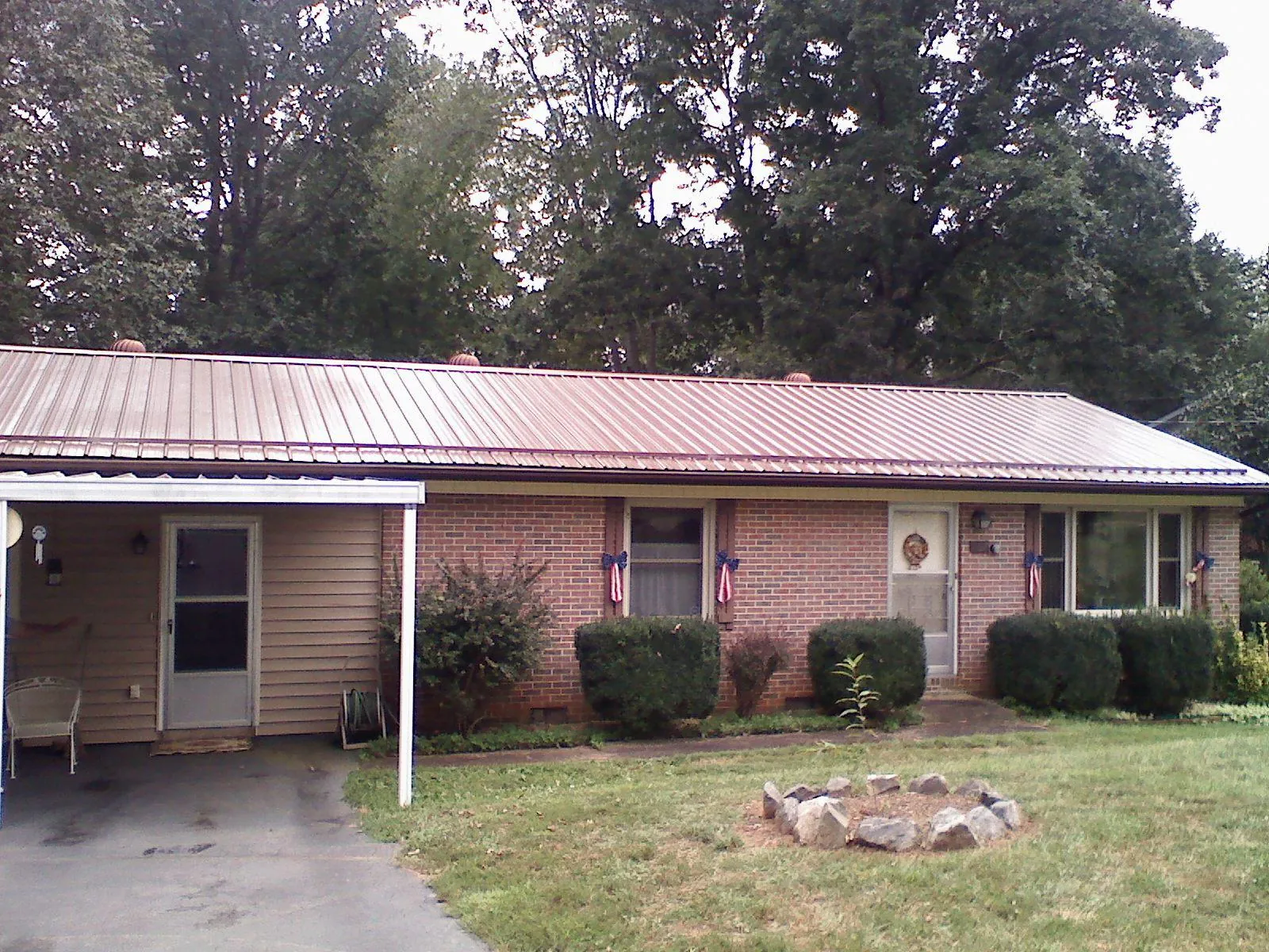Bronze metal roof and carport on a brick ranch home — Roof Repair work by our crew in Swampscott